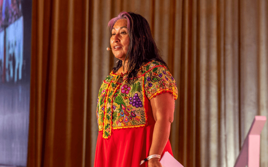 Odilia Romero stand at the #WeAllGrow stage presenting her keynote.