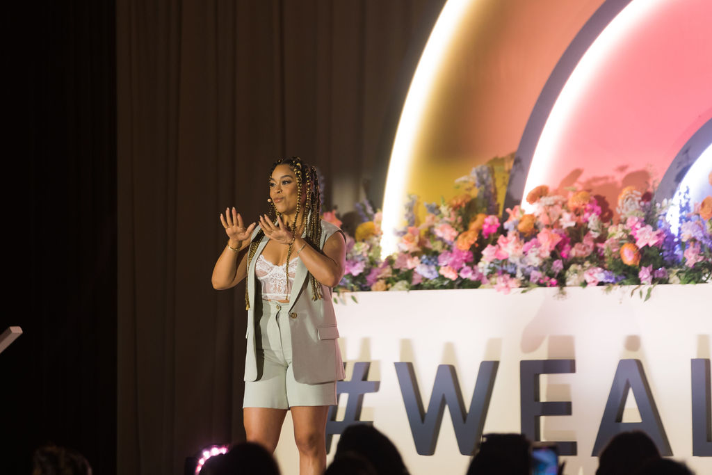 Actress and entrepreneur Julissa Calderón on stage as she delivers her talk on journaling and manifesting the life of your dreams at #WeAllGrow Summit 2022. 