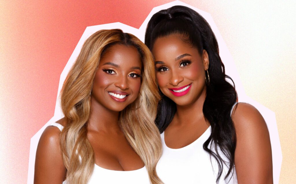 Afro-Latina founders of Luna Magic and sisters Shaira Frías (left) and Mabel Frías (right) are pictured next to each other smiling at the camera, and share their tips on starting a business together. Shaira has long wavy blonde hair parted down the middle that drapes over her shoulders. She is wearing a white tank top, gold hoops, has gold eyeshadow with bold lashes, and wears a natural auburn lip. Mabel next to her is a little taller than Shaira and has long black hair, that is in a half pony. Like Shaira, she also has gold hoops and white top, but has a hot pink lipstick on.