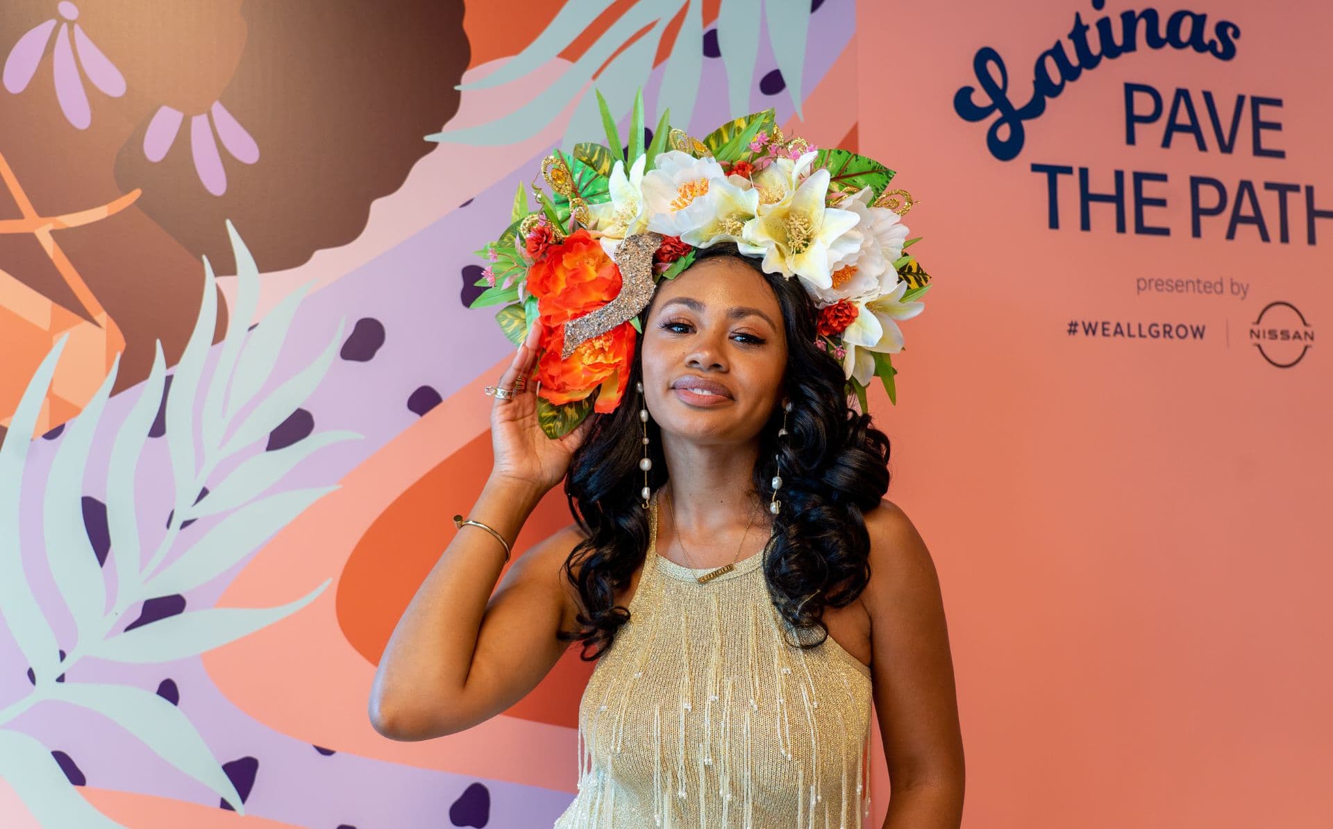 Visual artist and writer Reyna Noriega is shown with a crown of flowers at the Latinas Pave the Path event, a #WeAllGrow event in partnership with Nissan