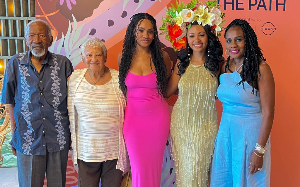 Afro-Latina Reyna Noriega poses with her family at the Latina Pave the Path #WeAllGrow event in partnership with Nissan.