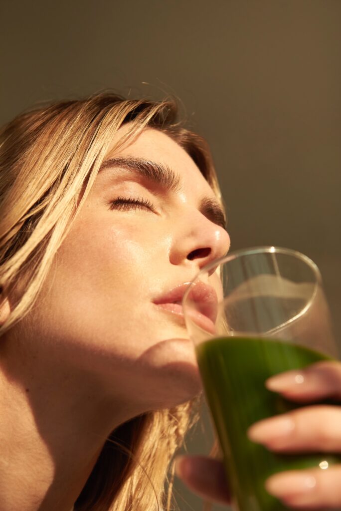 Supermodel and CEO of KAPOWDER Valentina Ferrer enjoys a green juice with KAPOWDER Vegan Protein Powder mixed in.